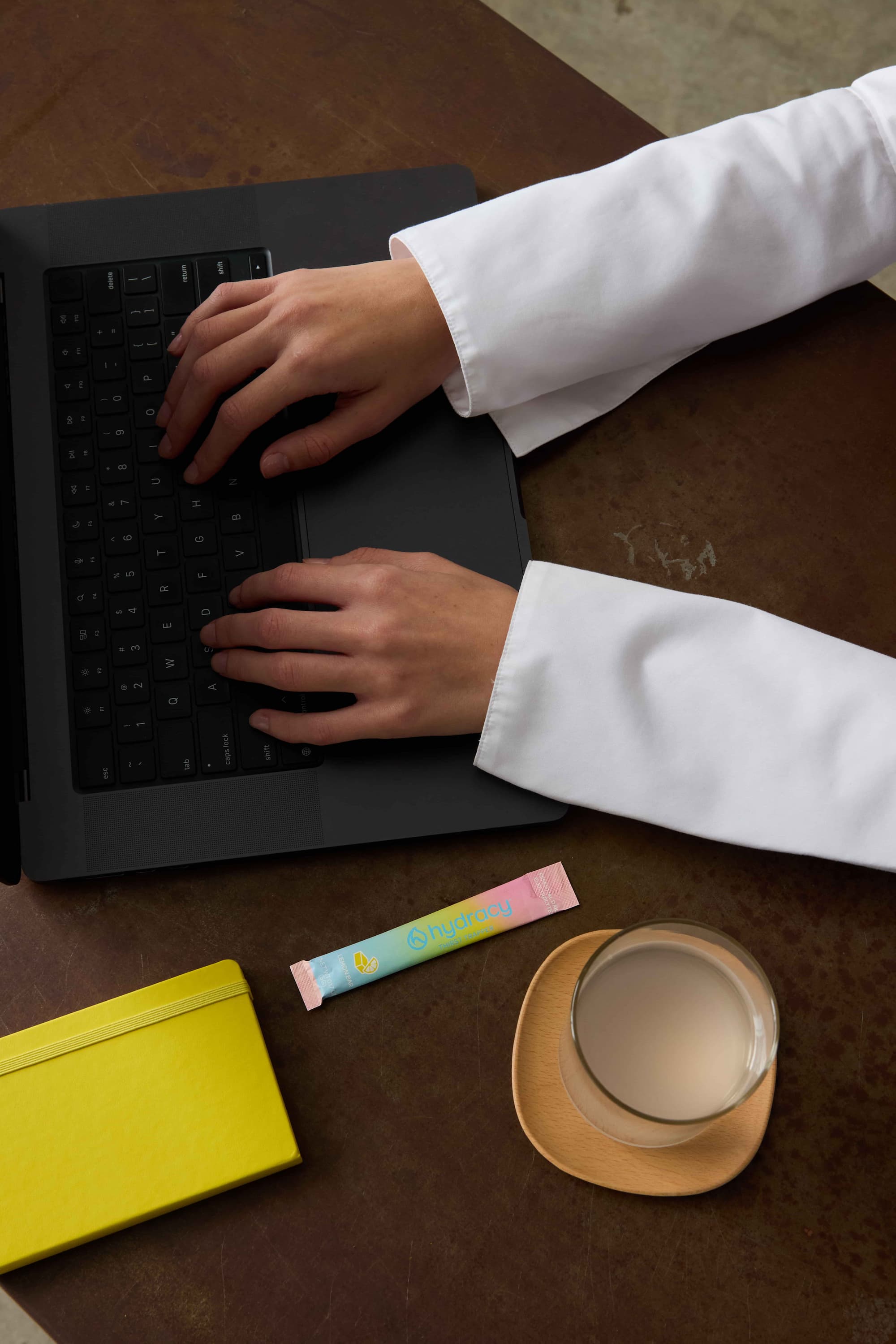 Hydracy stick pack next to laptop on desk