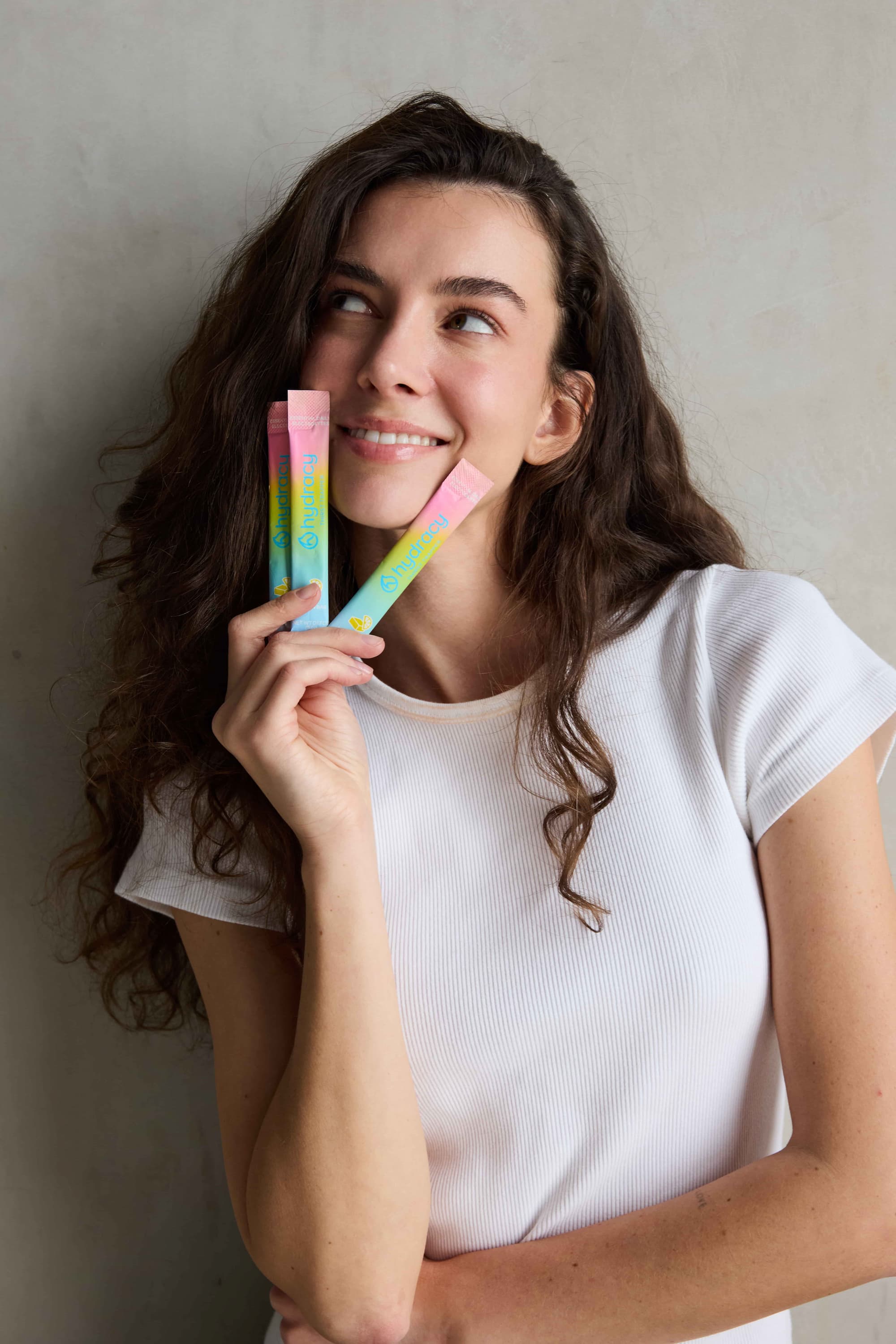 Woman smiling with Hydracy electrolyte sticks